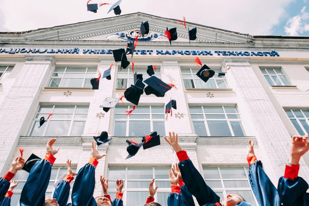 University students throwing their graduation caps in the air