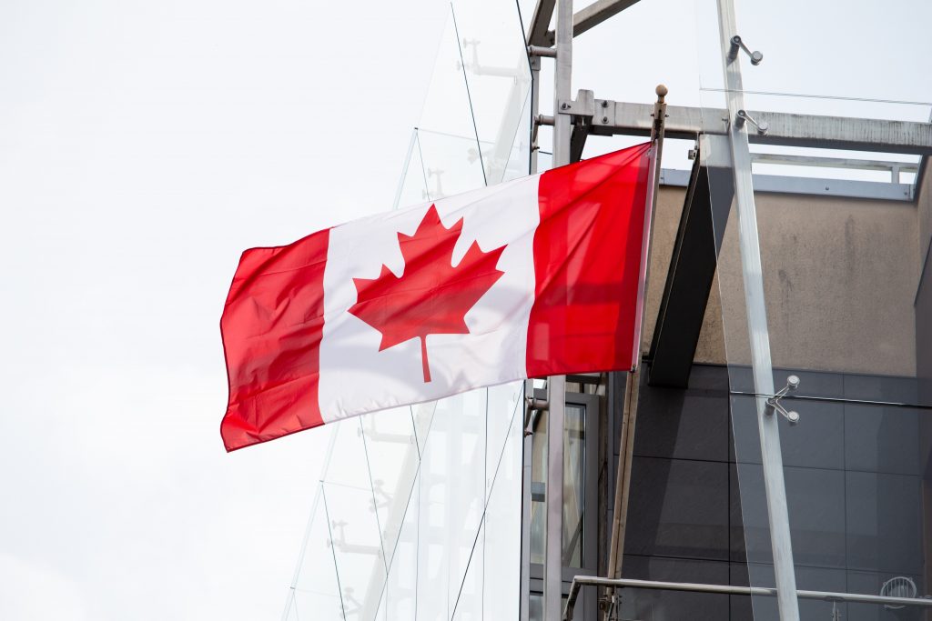 Canadian flag flying off building