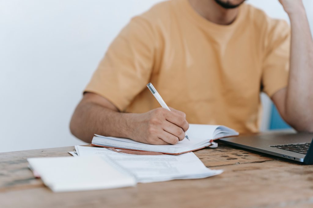 Person sitting at desk with paper preparing for an interview